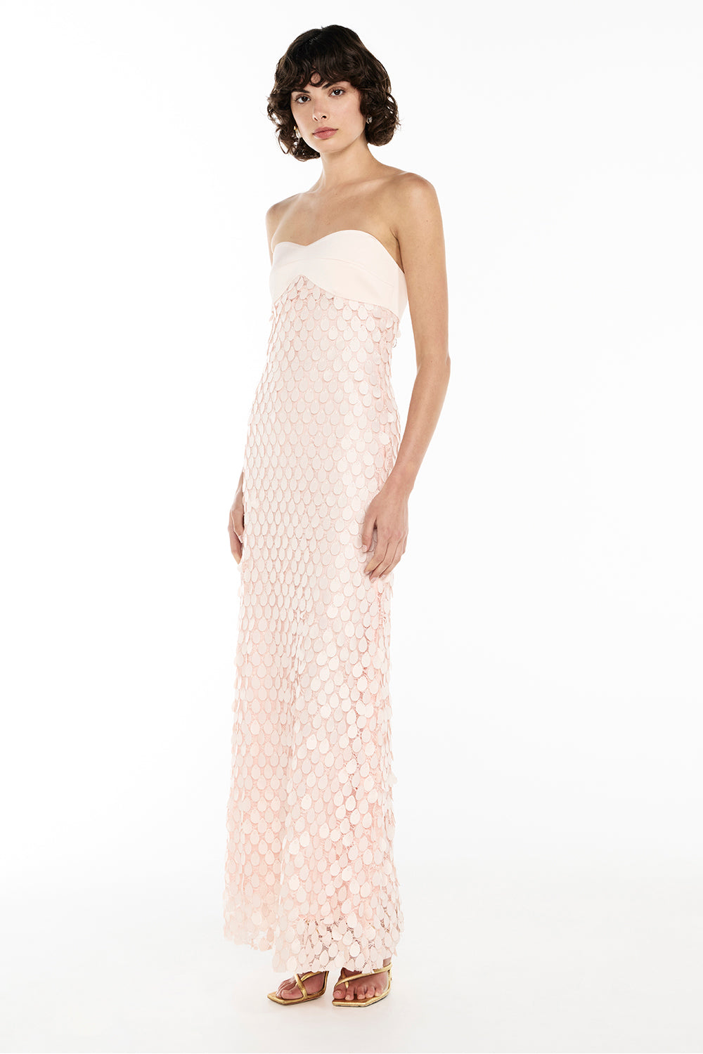 Woman wearing pink strapless textured dress with petal detail