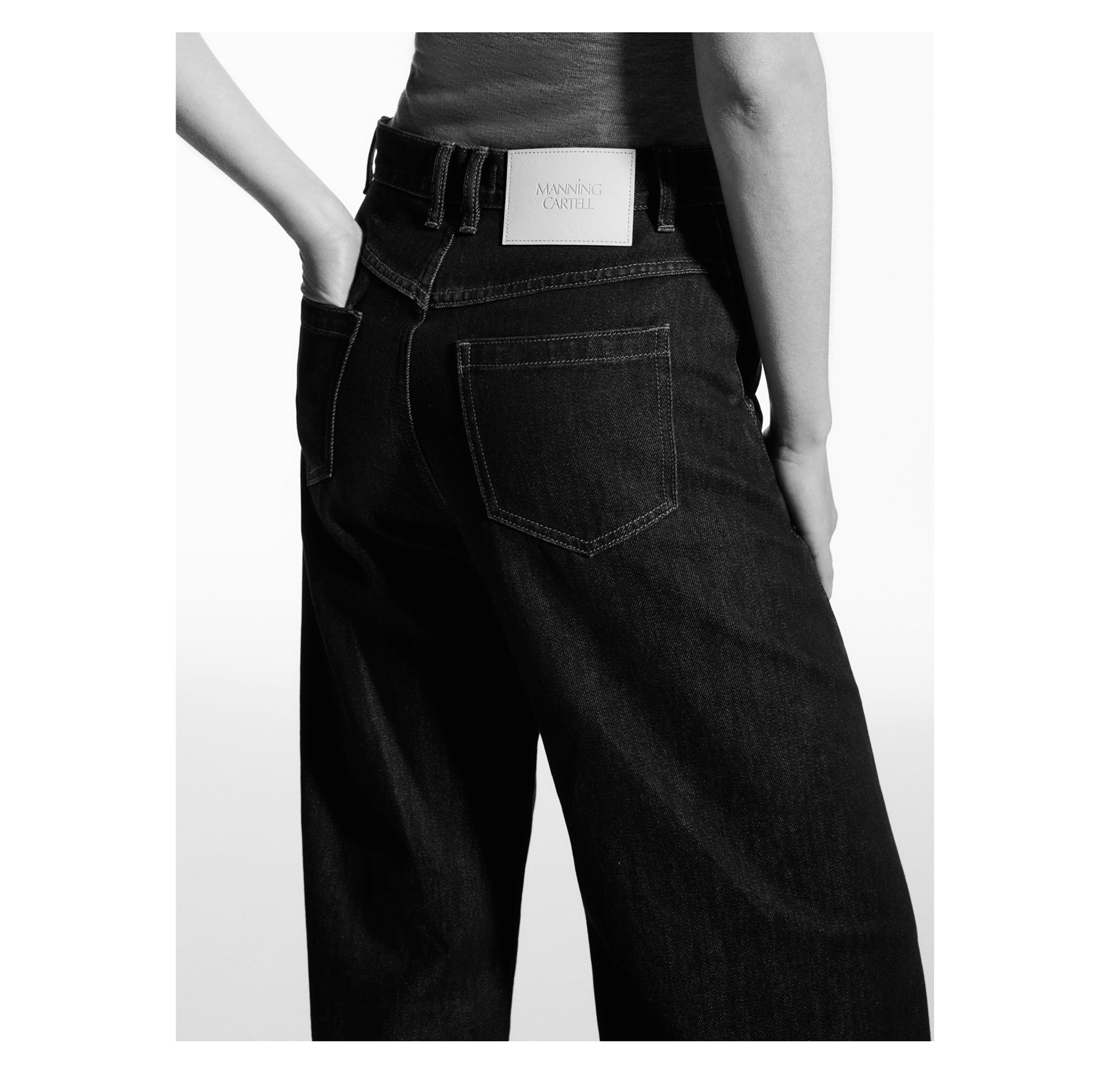 Dark wash barrel wide-leg jeans with a white brand patch on the waistband